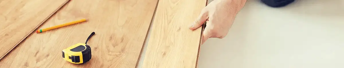 A professional installing wood flooring in Arlington, TX