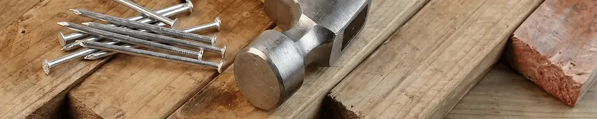 Hammer and nails on hardwood flooring boards in Arlington, TX